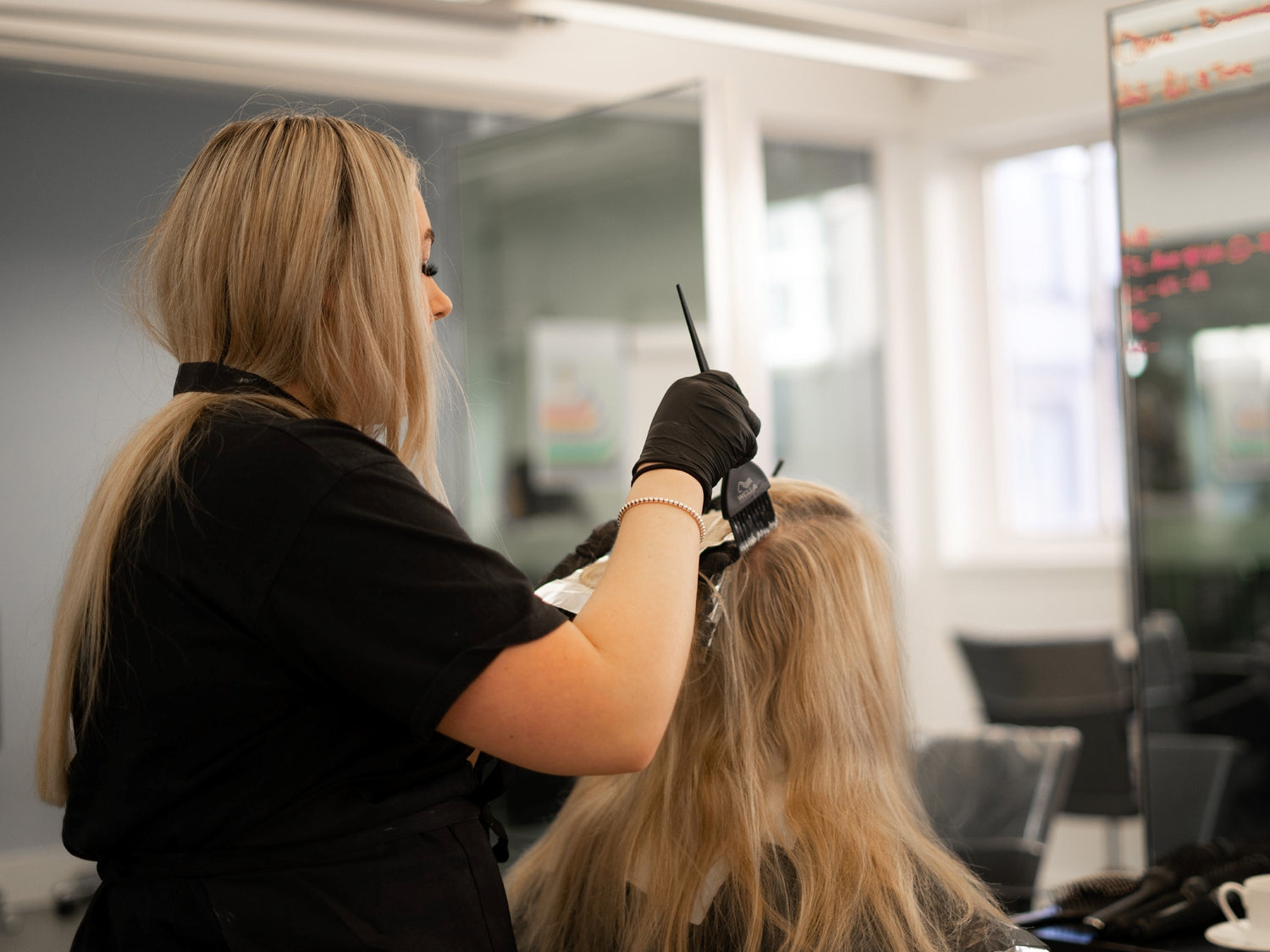 Apprentice applying bleach to foils